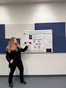 Researcher presenting findings with a poster